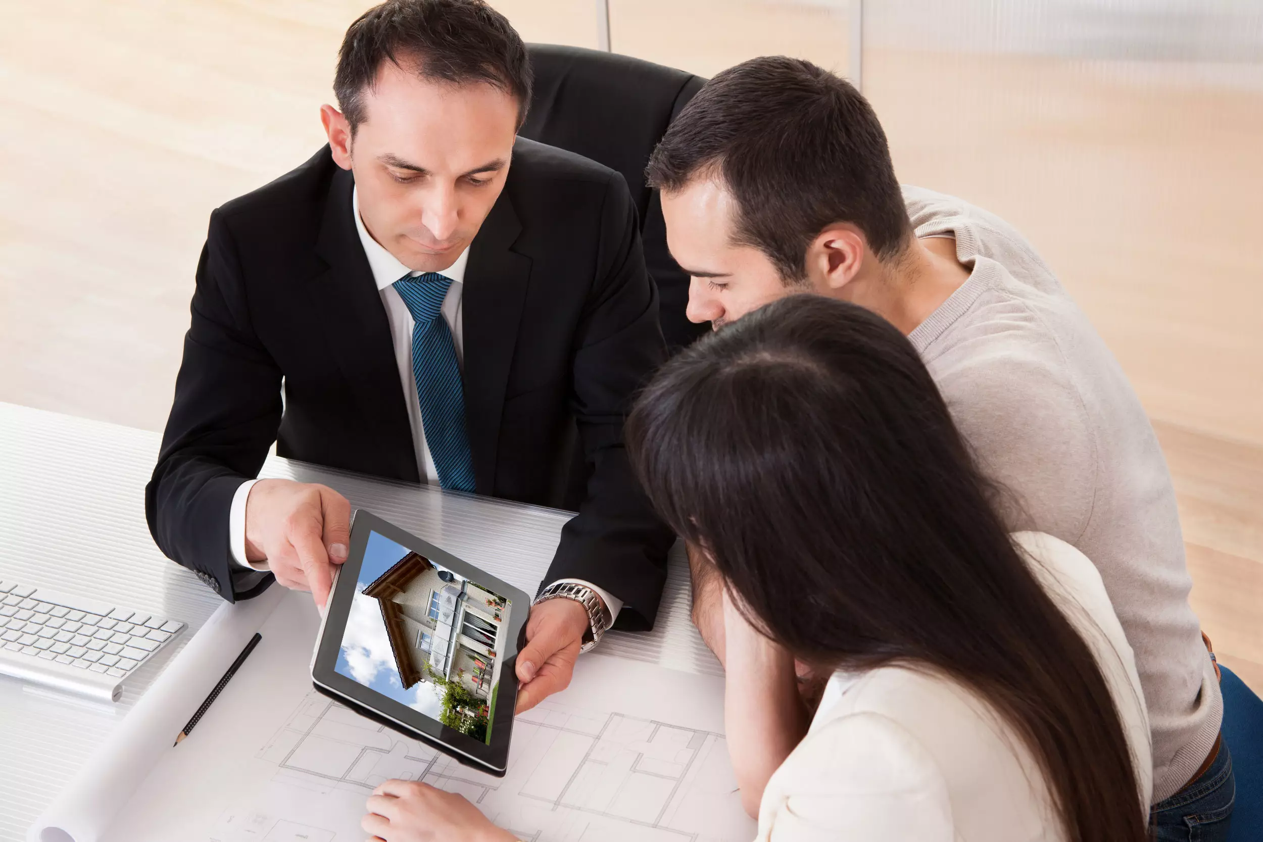 A title agent handing keys to a buyer